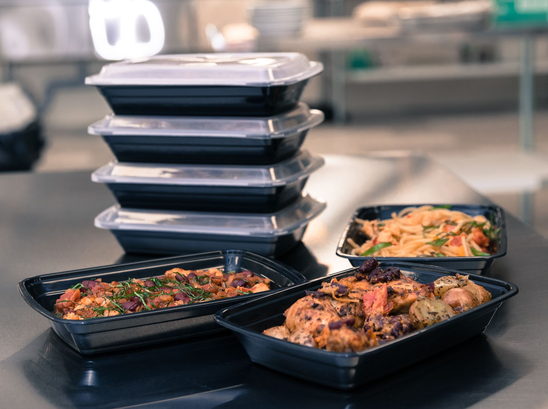 Trays of standardized Nutrics meals ready for portioning at a local partner kitchen